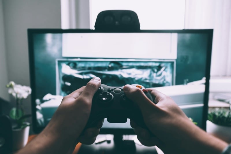 Game controller in front of a computer monitor.